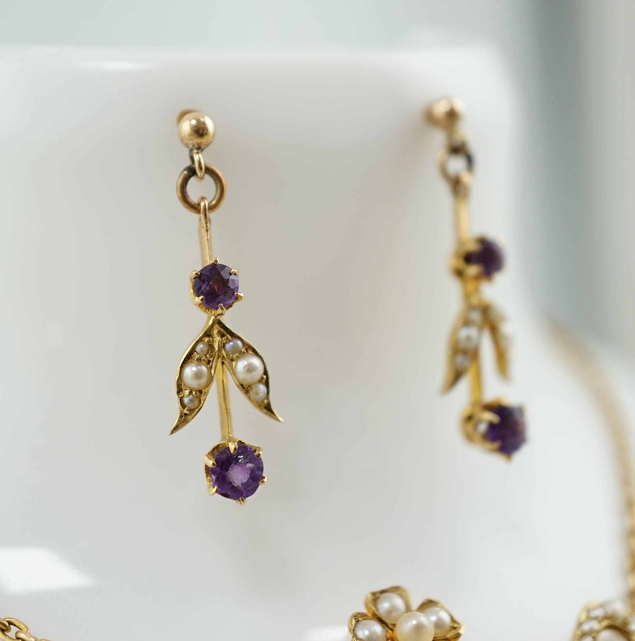An Edwardian 15ct gold, seed pearl and amethyst set drop necklace and a pair of matching unmarked earrings